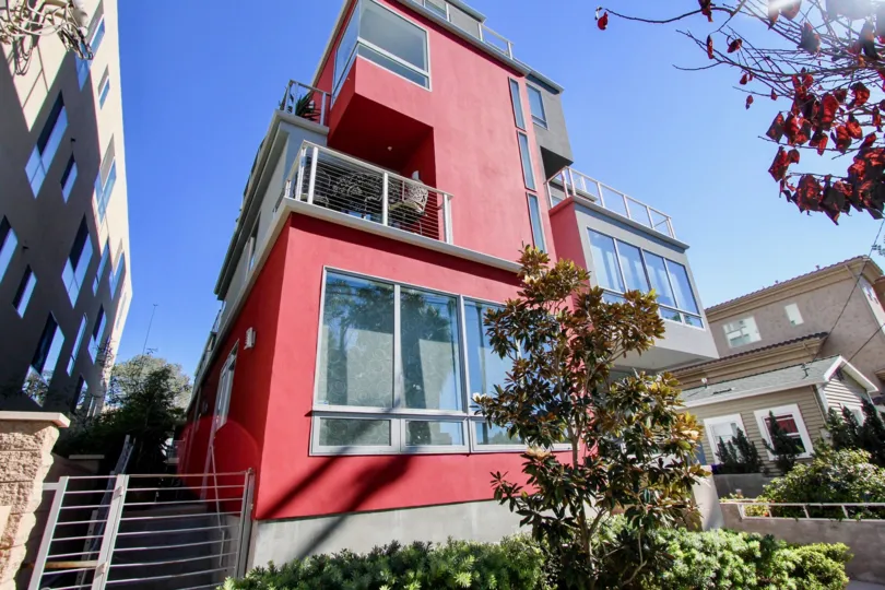 Red 5x5 Loft building in Hillcrest, California with trees on a bright sunny day