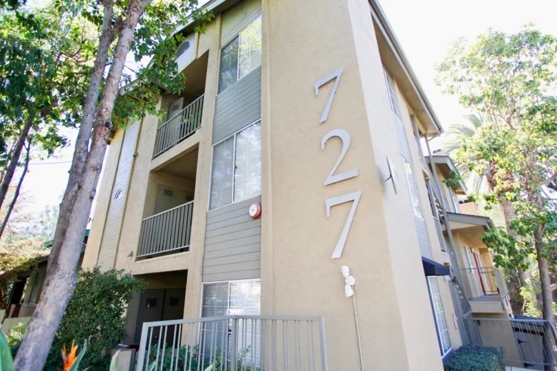 A large building with two levels with balconies and the number 727 at 727 Robinson community.