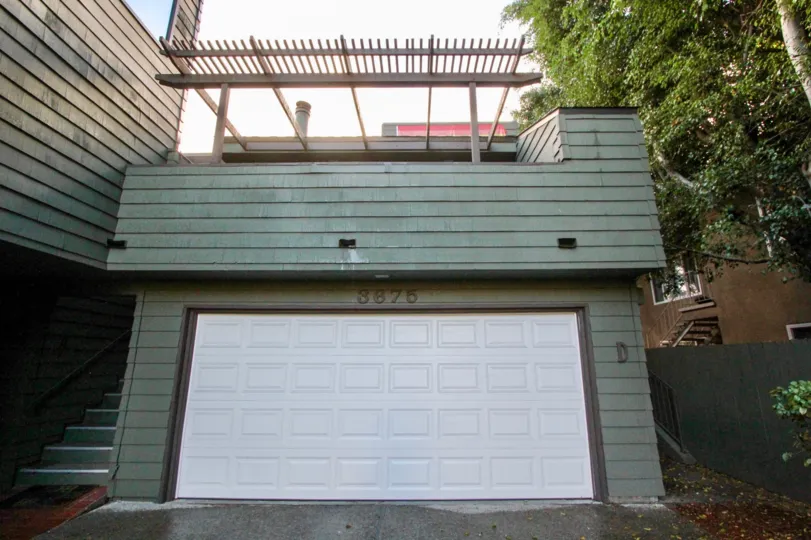 A sunny day in the 7th Avenue Condos with in front of a garage.