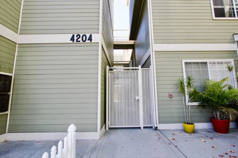 In the Wall of the Apartment in Arbor Village numbered with 4204 and has flower pots on one side