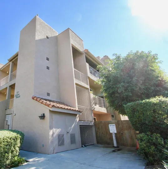 Arbor Woods tan multistory building with patios Hillcrest California