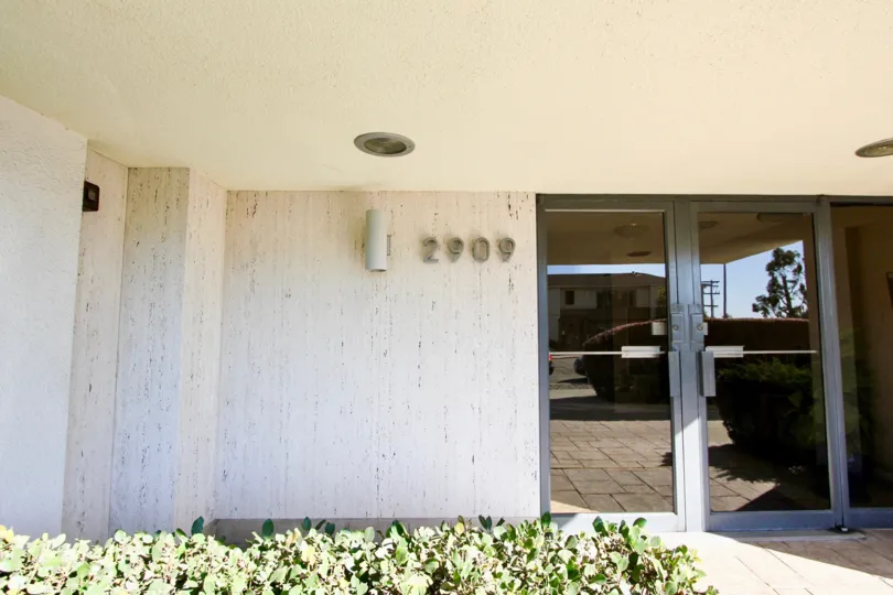 An entrance of a building in the Bridge Towers with glass door.