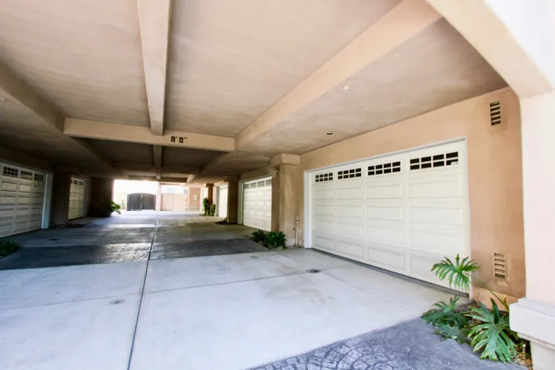ceiling on top and garage doors on both sides with the straight path leading inside
