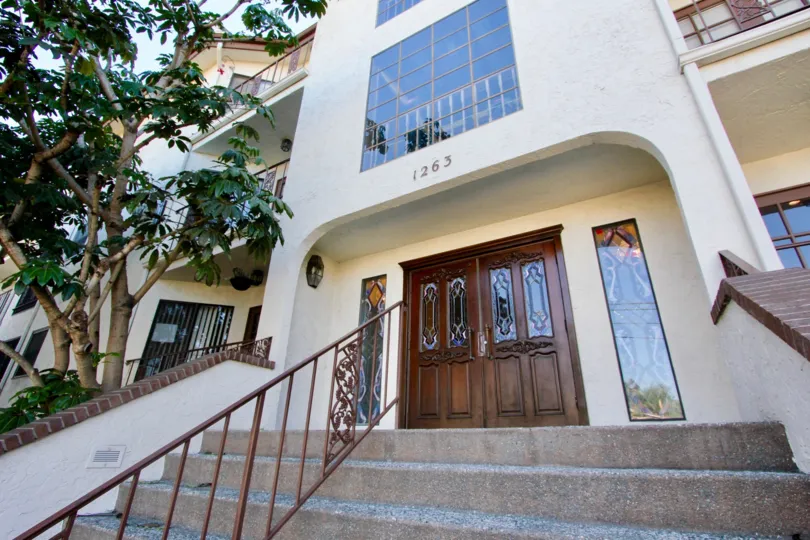 The Apartment in Burgundy House has trees and stairs on sunny day