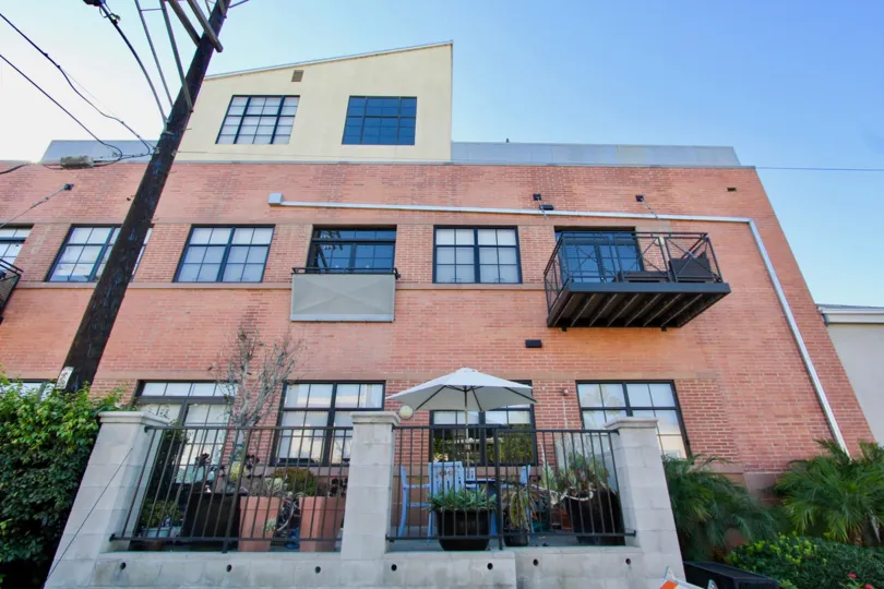 A sunny day in the Cable Building Lofts with residential building and plants.