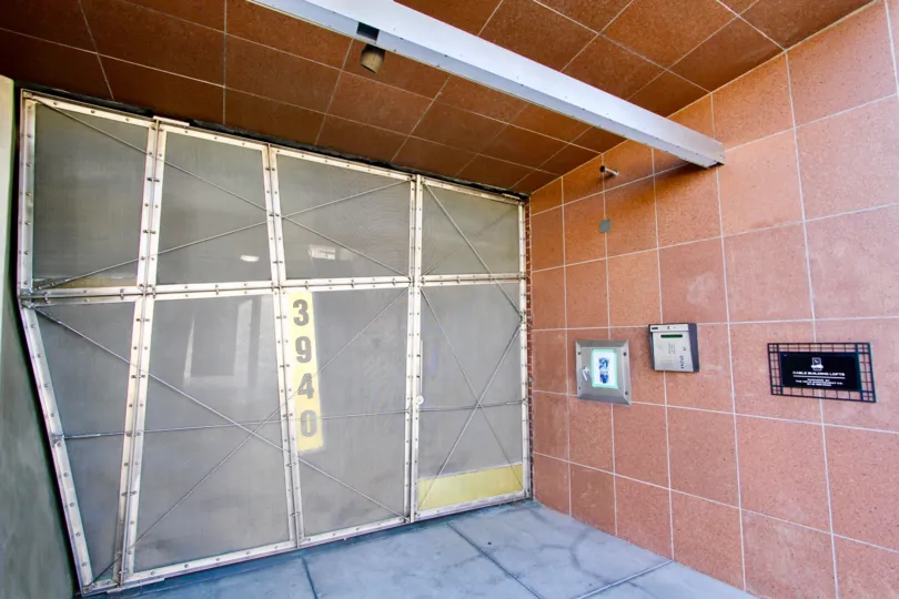 A modern metal gate with tiled walls in the Cable Building Lofts community.