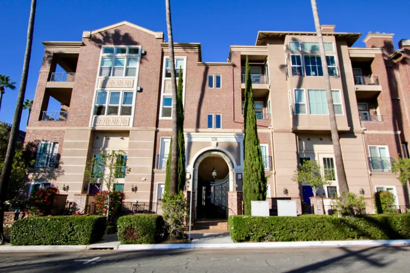A traditional three-storey townhomes with brick cladding in the Cambridge Square neighborhood.
