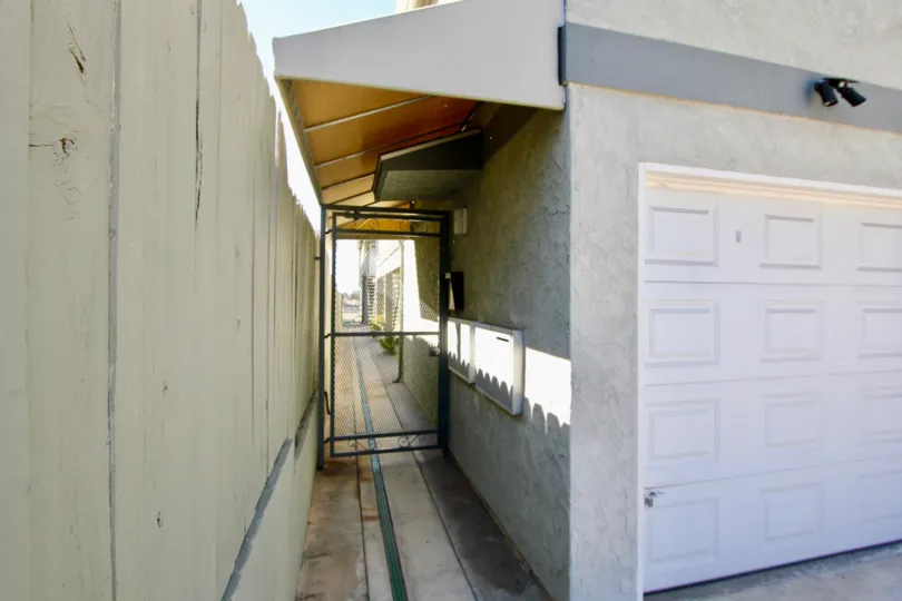 THE VILLAS IN THE CAMPUS VILLAS WITH THE PATHWAY, GATE, ELECTRIC BOX