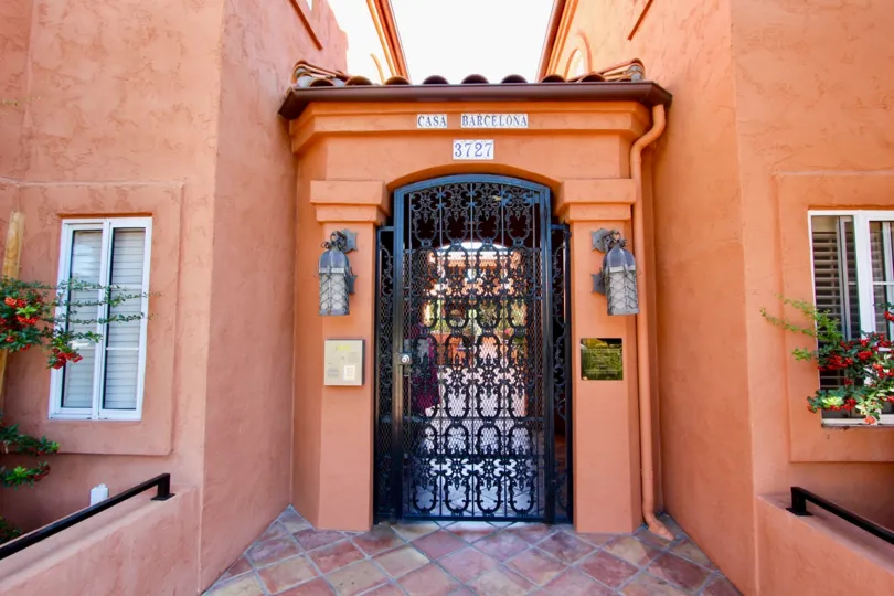 A sunny day in the area of Casa Barcelona, gated entrance, condos, flowers, lights, buzzer