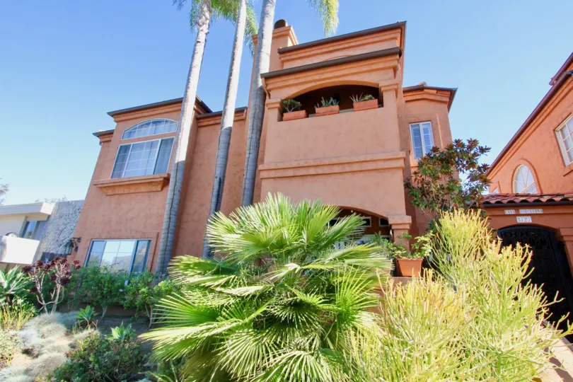 Casa Barcelona two-story brown orange building with landscaping Hillcrest California