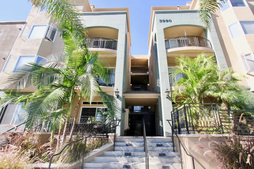 A sunny day in the Centre Court Condominiums with residential apartment and trees.
