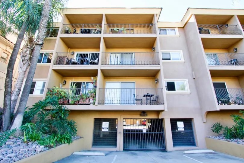 Cliffbridge Estates four-story beige building with gated entry Hillcrest California