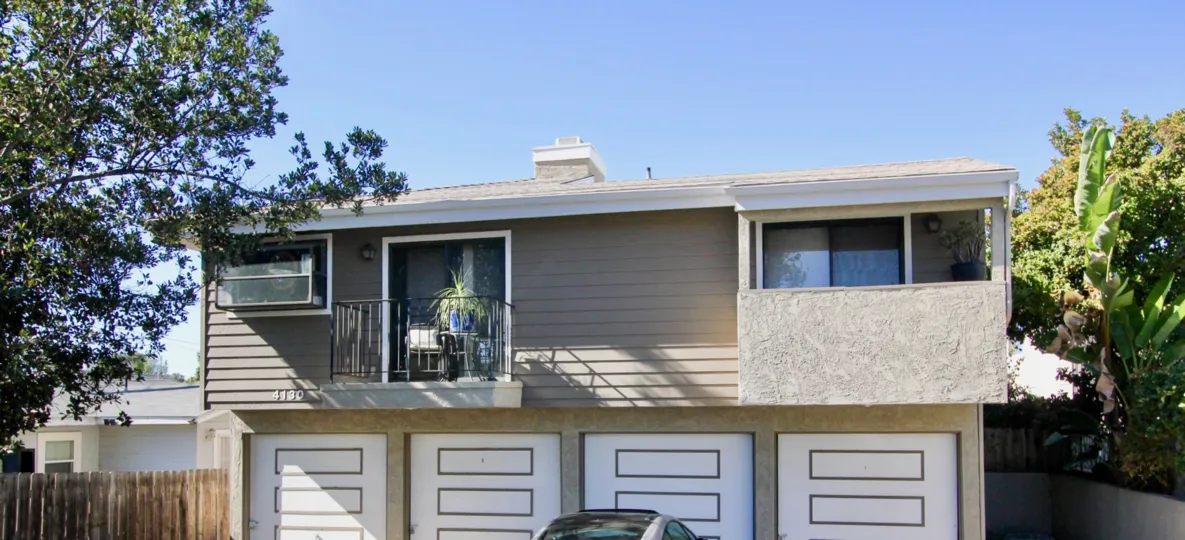 A two-storey residence with panelled carports in Condos at 4130 Cleveland community.