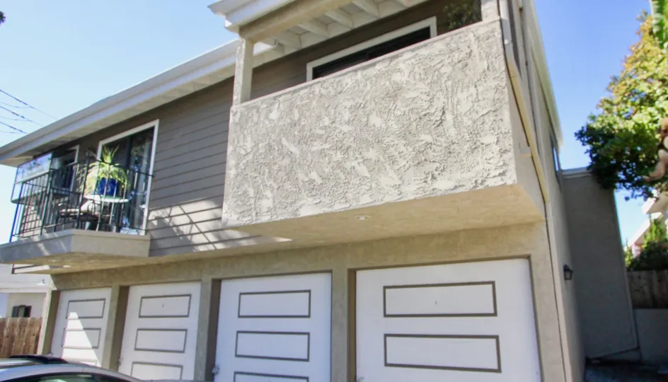 THE APARTMENT IN THE CONDOS AT 4130 CLEVELAND WITH THE CAR PARKING, SHUTTERS, CHAIR, FLOWER POT, TREES, BALCONI