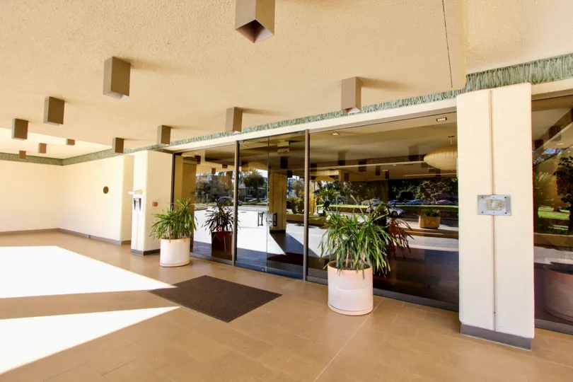 A foyer witch carmel cream stucco finish and glass doors in the Del Prado community in Hillcrest, California