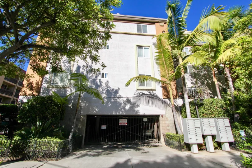 Postal boxes is placed outside the apartment in Essex Place with trees and plants