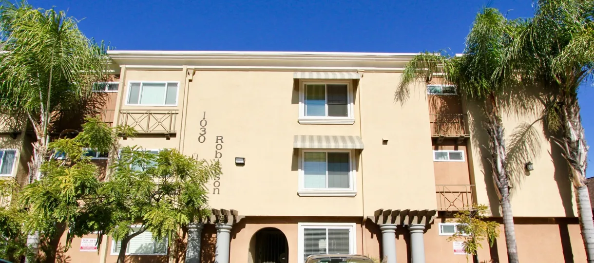 THE 1030 APARTMENT IN THE HILLCREST TOWERS WITH THE CAR, PLANTS, TREES