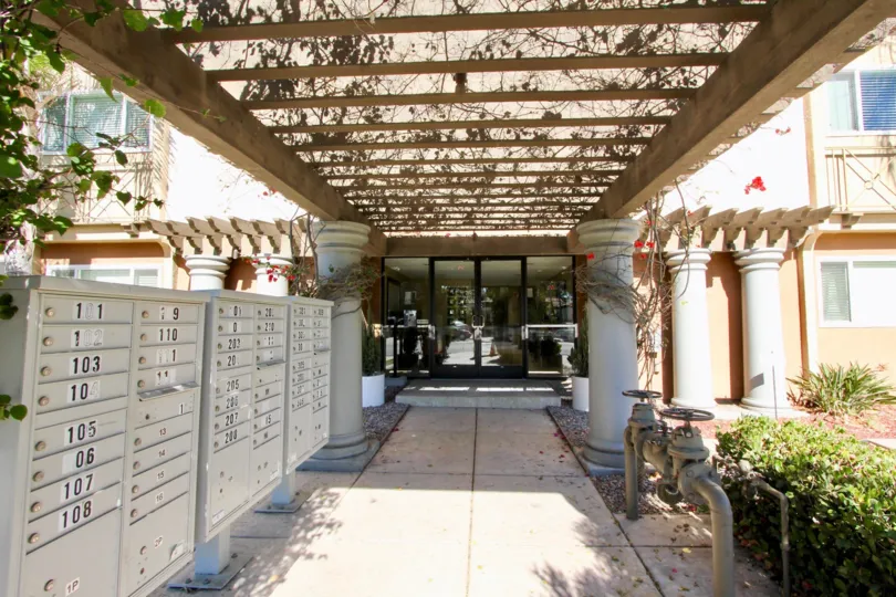 An entrance of a building in the Hillcrest Towers with beautiful plants.