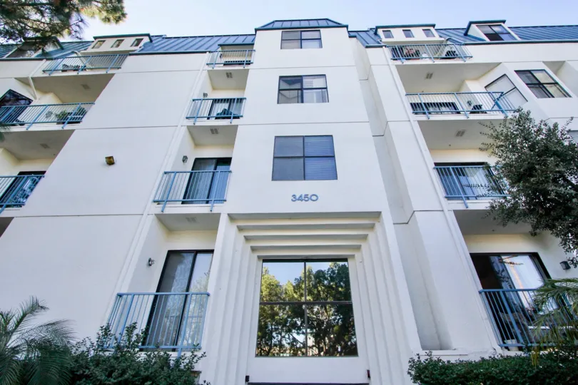 A sunny day in the Le Parc Chateau with residential apartment and plants.