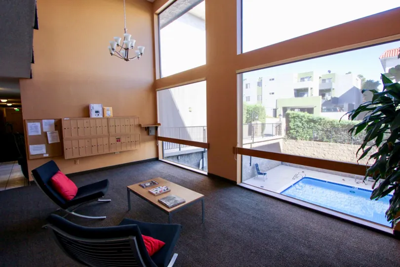 THE APARTMENT IN THE MISSION CREST GARDENS WITH THE TABLES, SWIMMING POOL, GLASS DOOR