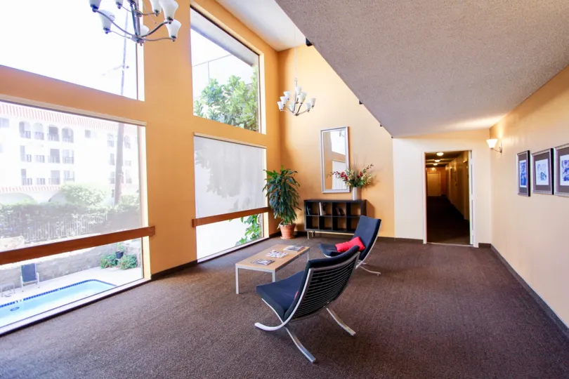 Inside the Apartment in Mission Crest Gardens has chairs and tables and swimming pool in outside