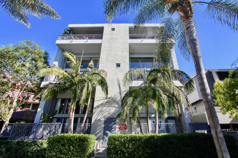 Montana Lofts white three-story building with landscaping Hillcrest California
