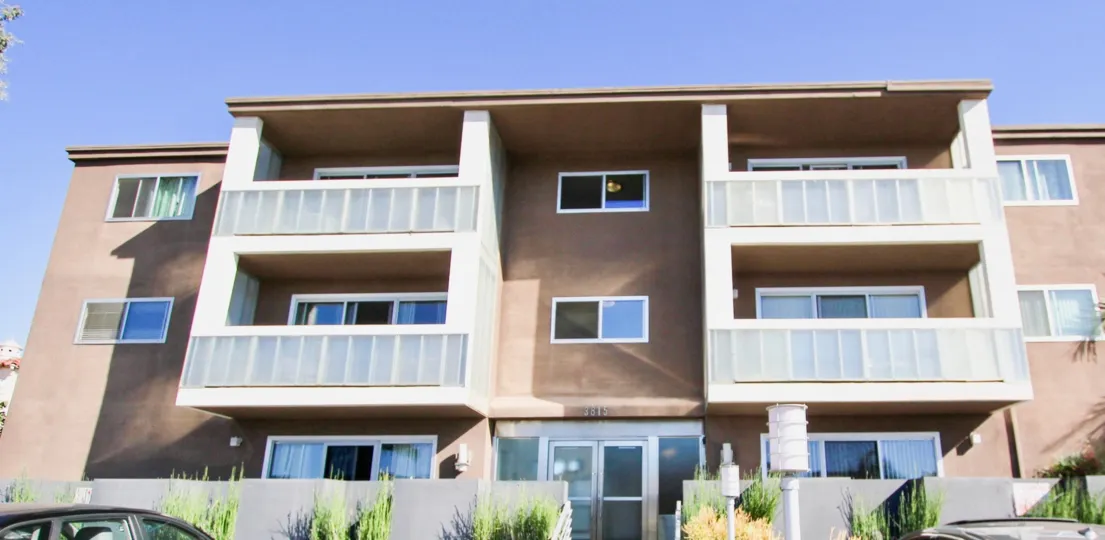 The Apartment with number 3815 On Third has bushes and car is parking