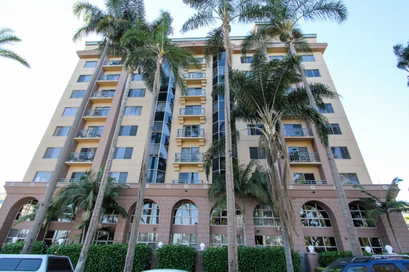 The Park West building very big in size and there are many palm tree in front of the building