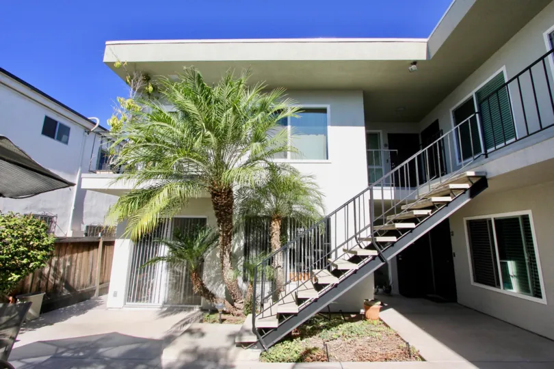 A sunny day in the Robinson Ave Villa with residential building and stairs.