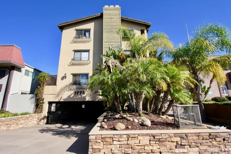 A sunny day in the area of Sussex Villas, outside, condos, palm trees, windows, roof