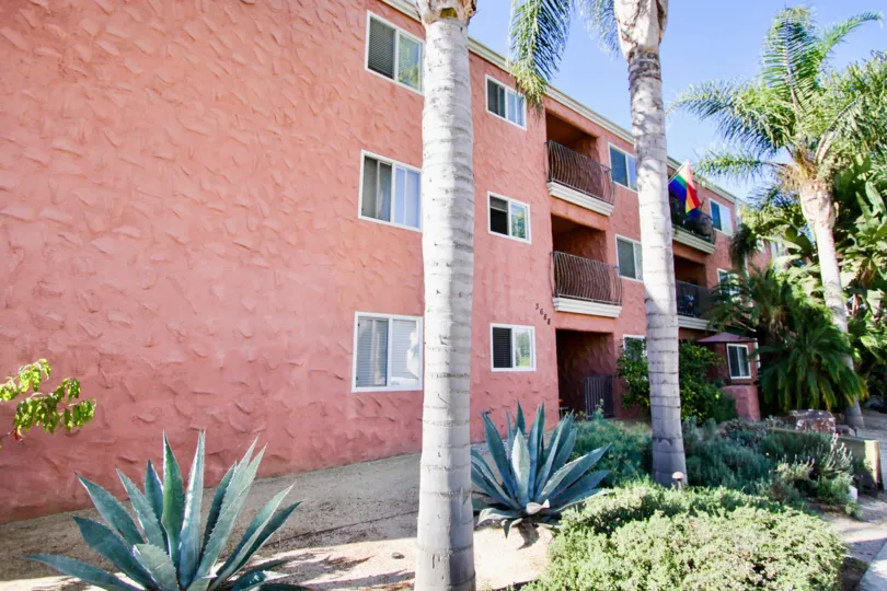 Flag is hanger in the balcony of the apartment in Terrace Village with Bushes and trees