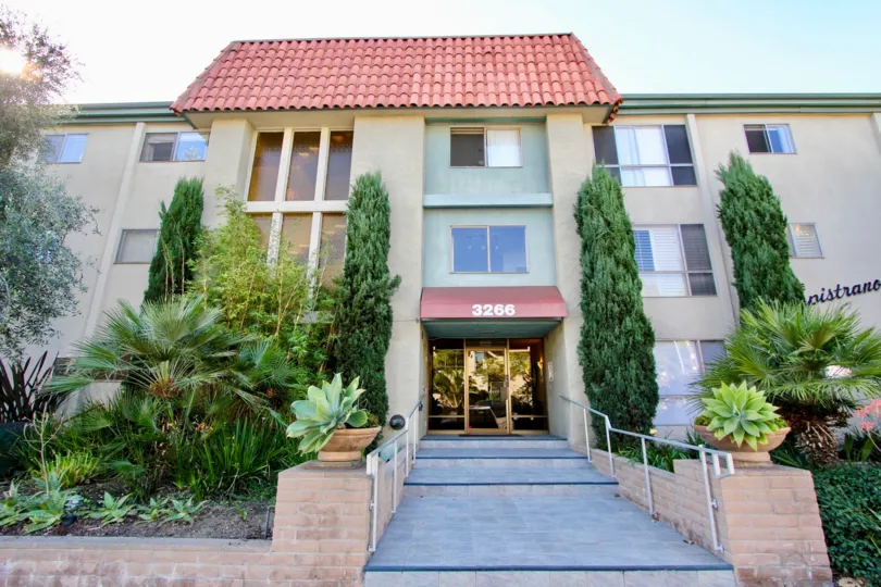 A sunny day in the The Capistrano with residential building and plants.