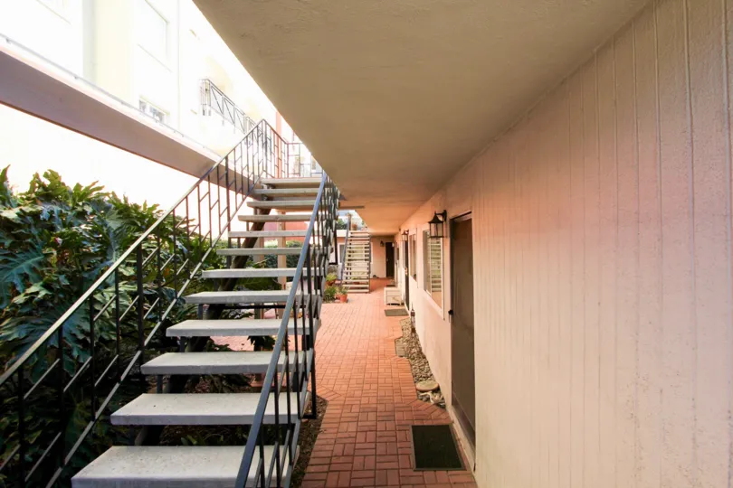 Near the Stairs inside the Apartment has plants and bushes of The Orleans