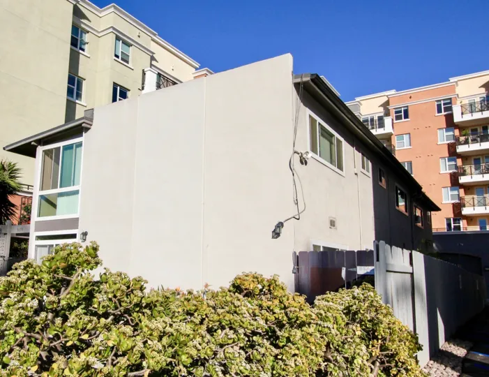 A plain townhouse painted in grayish color in the The Orleans community.
