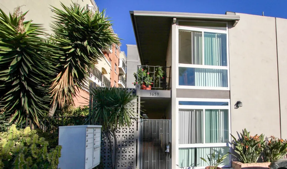 A sunny day in the area of the Orleans, palm trees, balcony, condo, flowers, gated entrance