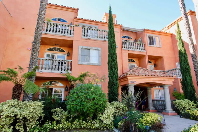 a sunny day in the trevi villa with a big house that is numbered as 3620 and has tall trees in front of it