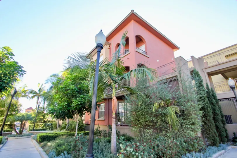 A sunny day in the Uptown District with residential building and trees.