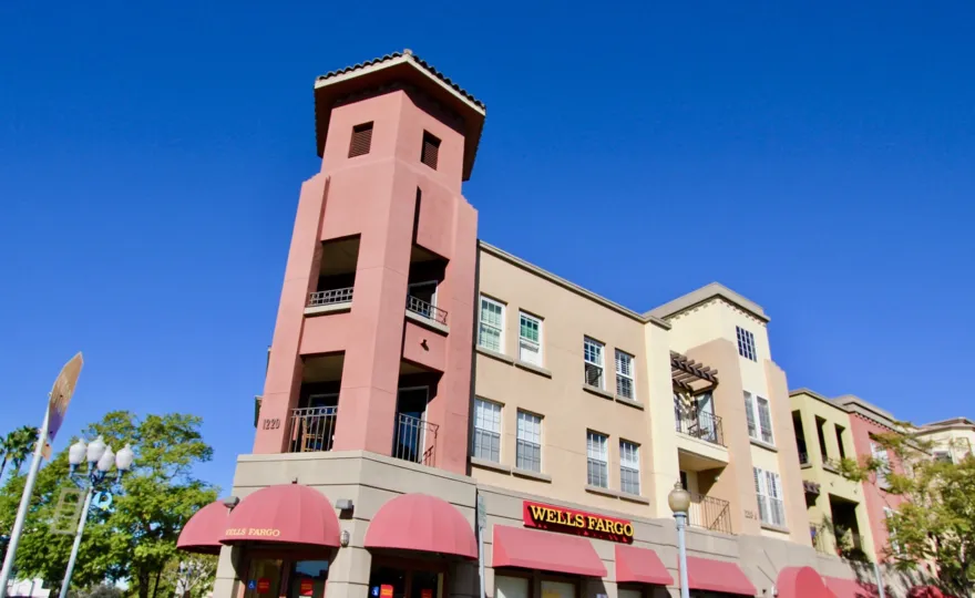 The building in Uptown District has board Wells Fargo and light lamps in street