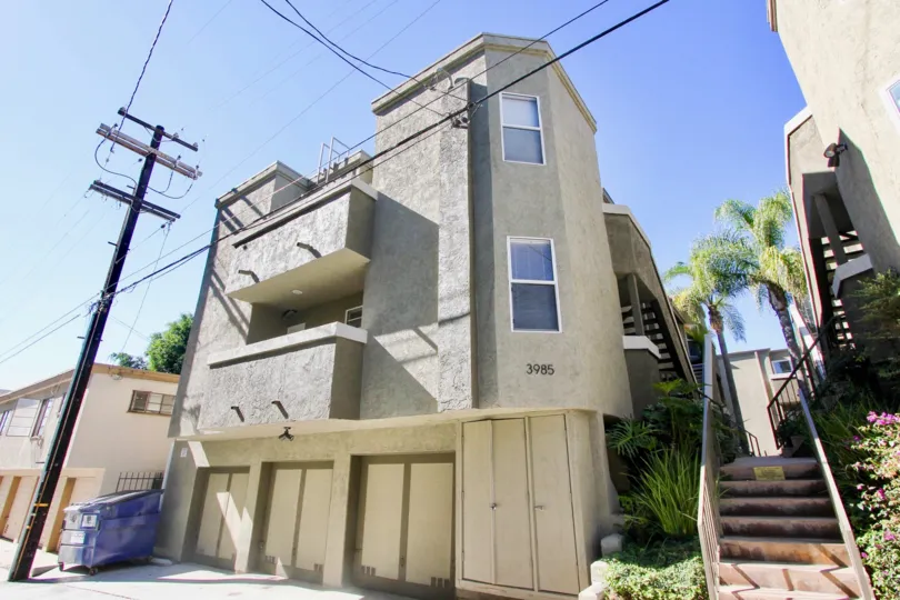 A modern three-storey residence in Uptown Villas West community with an exterior staircase.