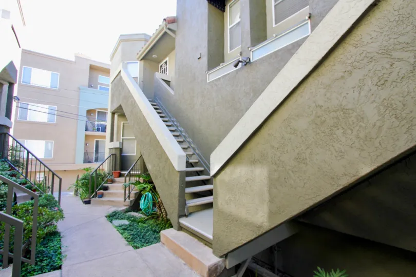 Flower pots is placed in the stairs to the apartment in Uptown Villas West