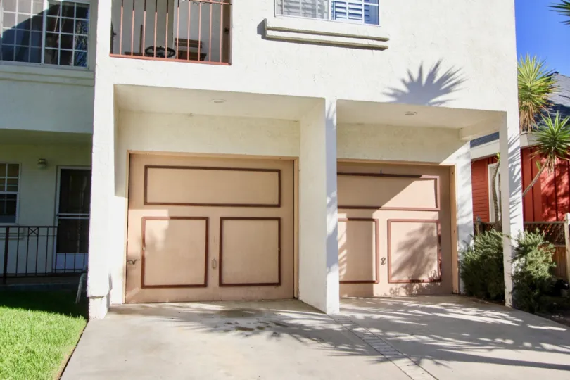 A closed garage with paneled doors in the Uptown West community.