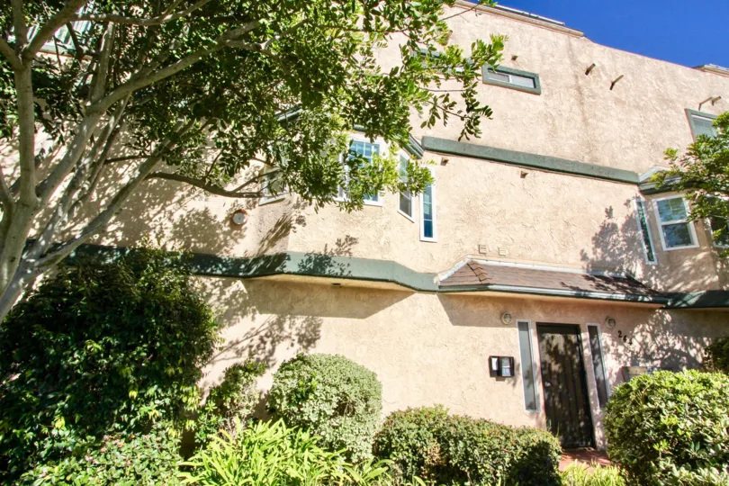Three story residential building near trees at Casa De La Playa in Imperial Beach CA