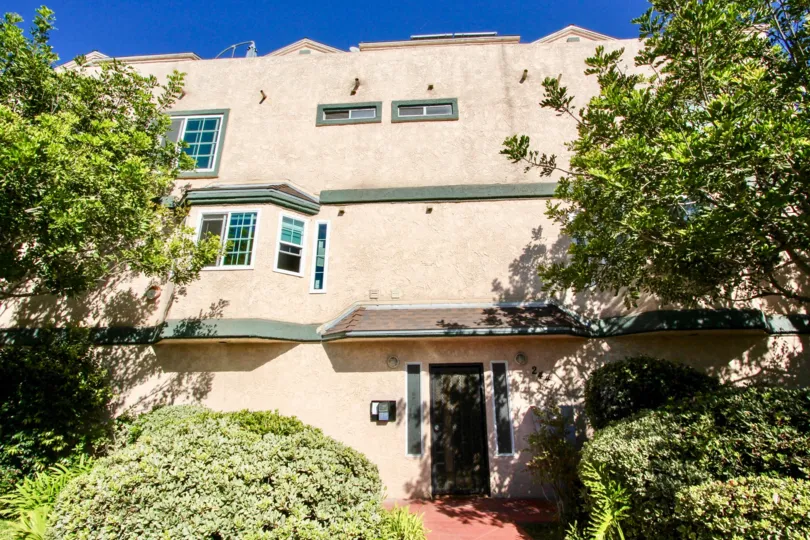 Three story residential buildings with plants Casa De La Play in Imperial Beach CA
