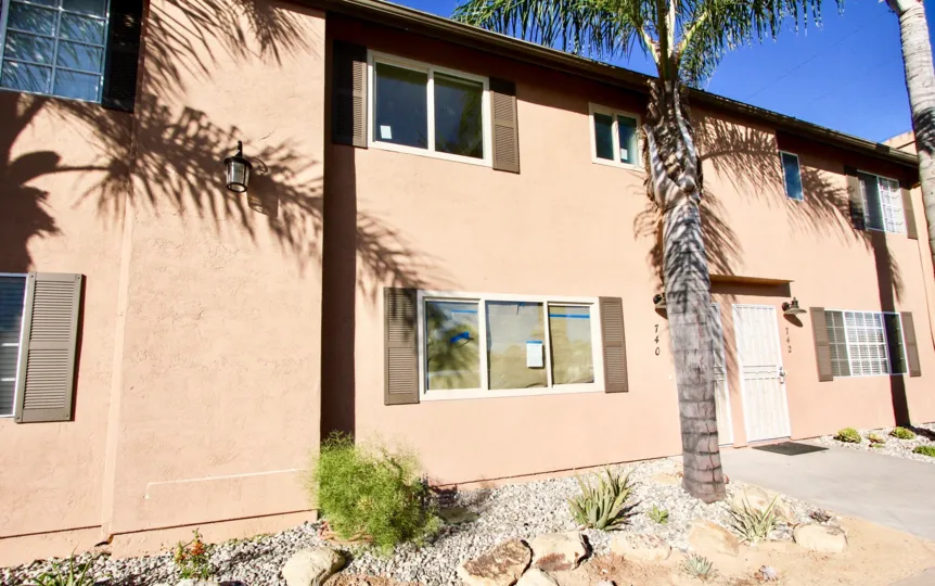 Two story residential building with palm trees at Cherry Breeze in Imperial Beach California