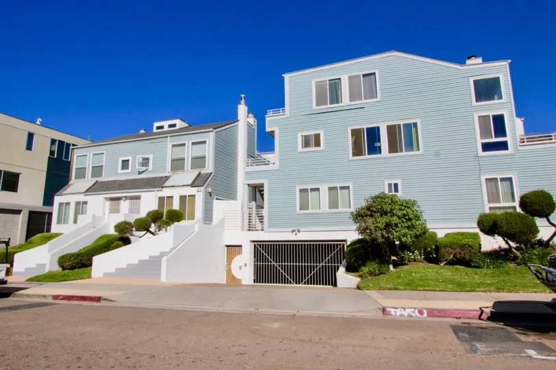 Beautiful multilevel townhomes with big windows on a bright day.
