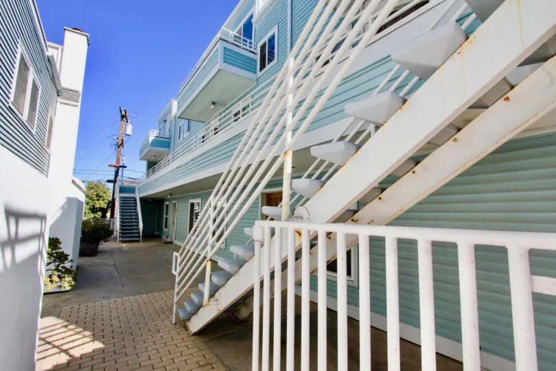 Blue townhomes that are multiple levels located in Coastwalk Townhomes community.