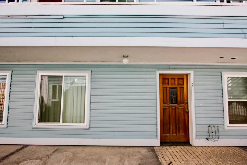 The front of a house, showing a front door and a window in Coastwalk Townhomes, Imperial Beach, CA