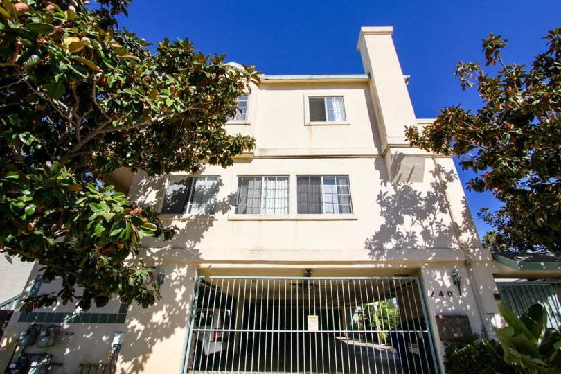 Front view of Villa in Dahlia has car facilities and has trees on the road side