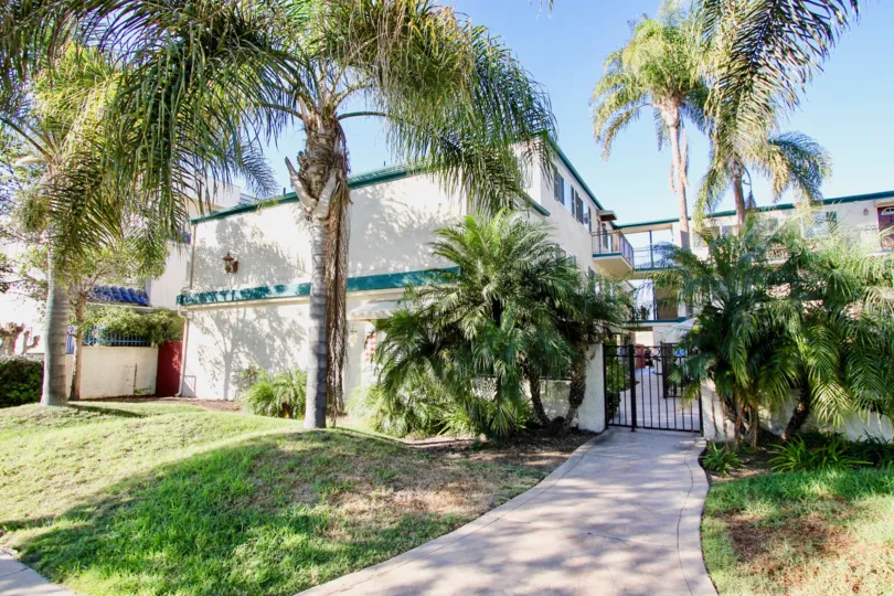 Two story residential building with black gate at Dolphin Bay in Imperial Beach CA