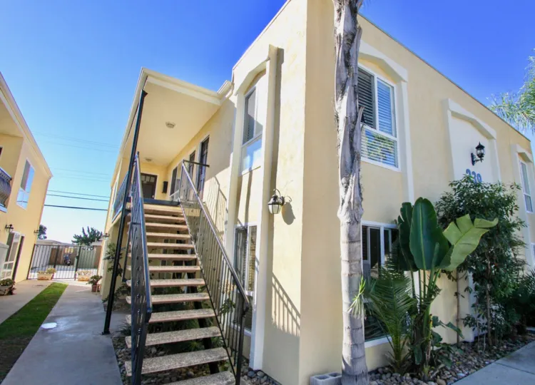 The side of an apartment building at Ebony Estates in Imperial Beach, California, showing the staircase.